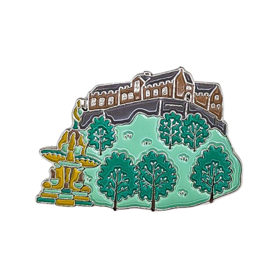 Enamel pin badge featuring a miniature version of Edinburgh Castle with Princes Street Gardens and the Ross Fountain.