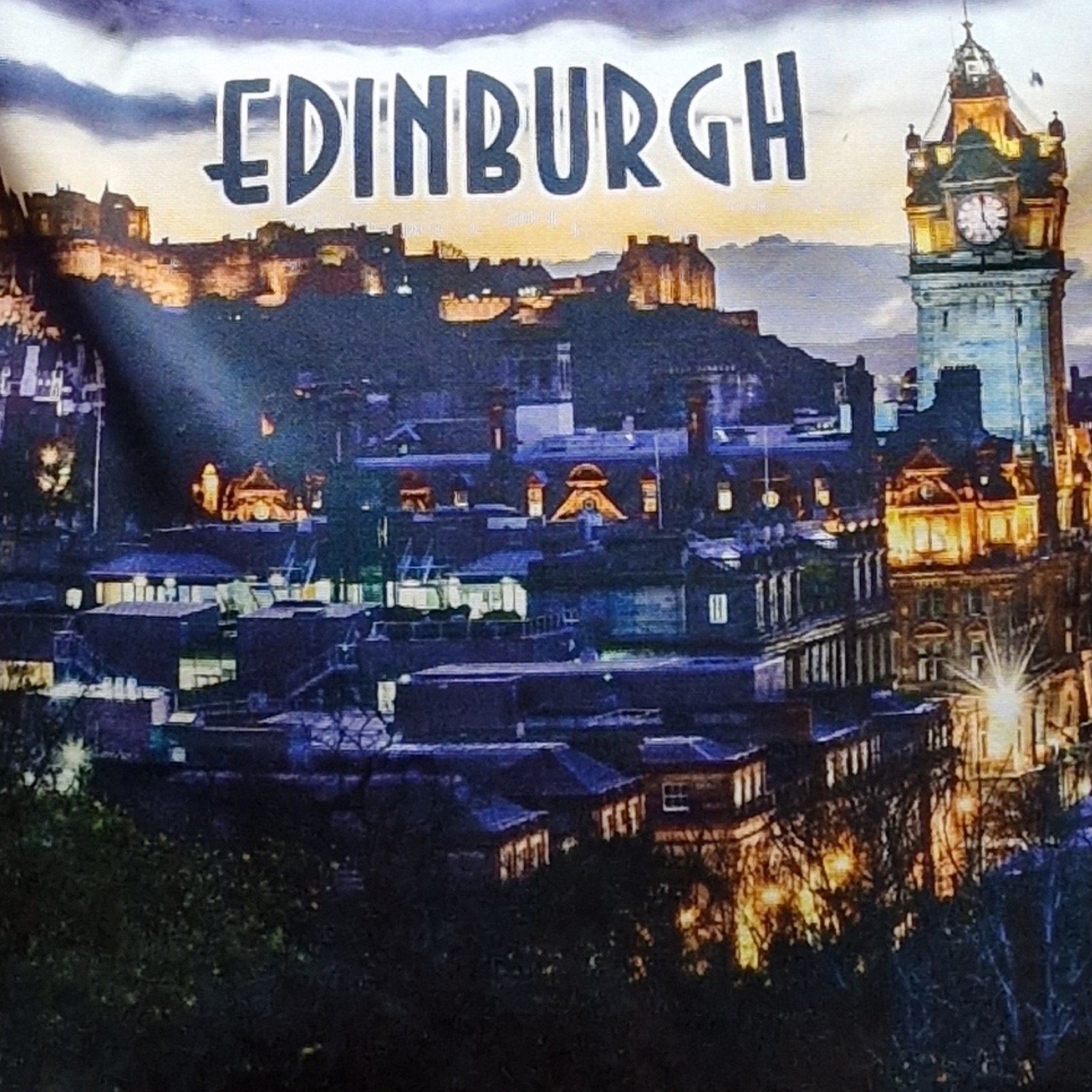 A tote bag with a printed image of the Edinburgh skyline, including Edinburgh Castle.
