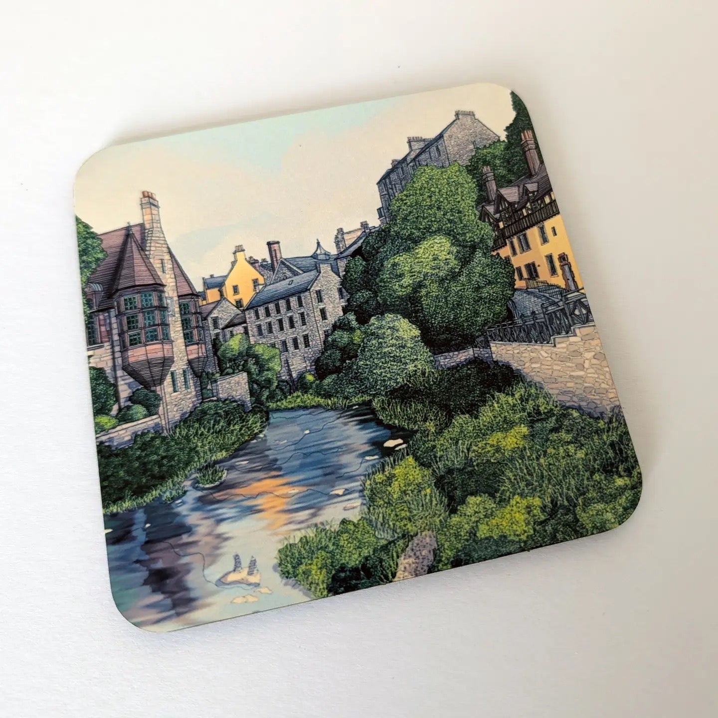 Coaster with an illustration of the Dean Village on a white background.