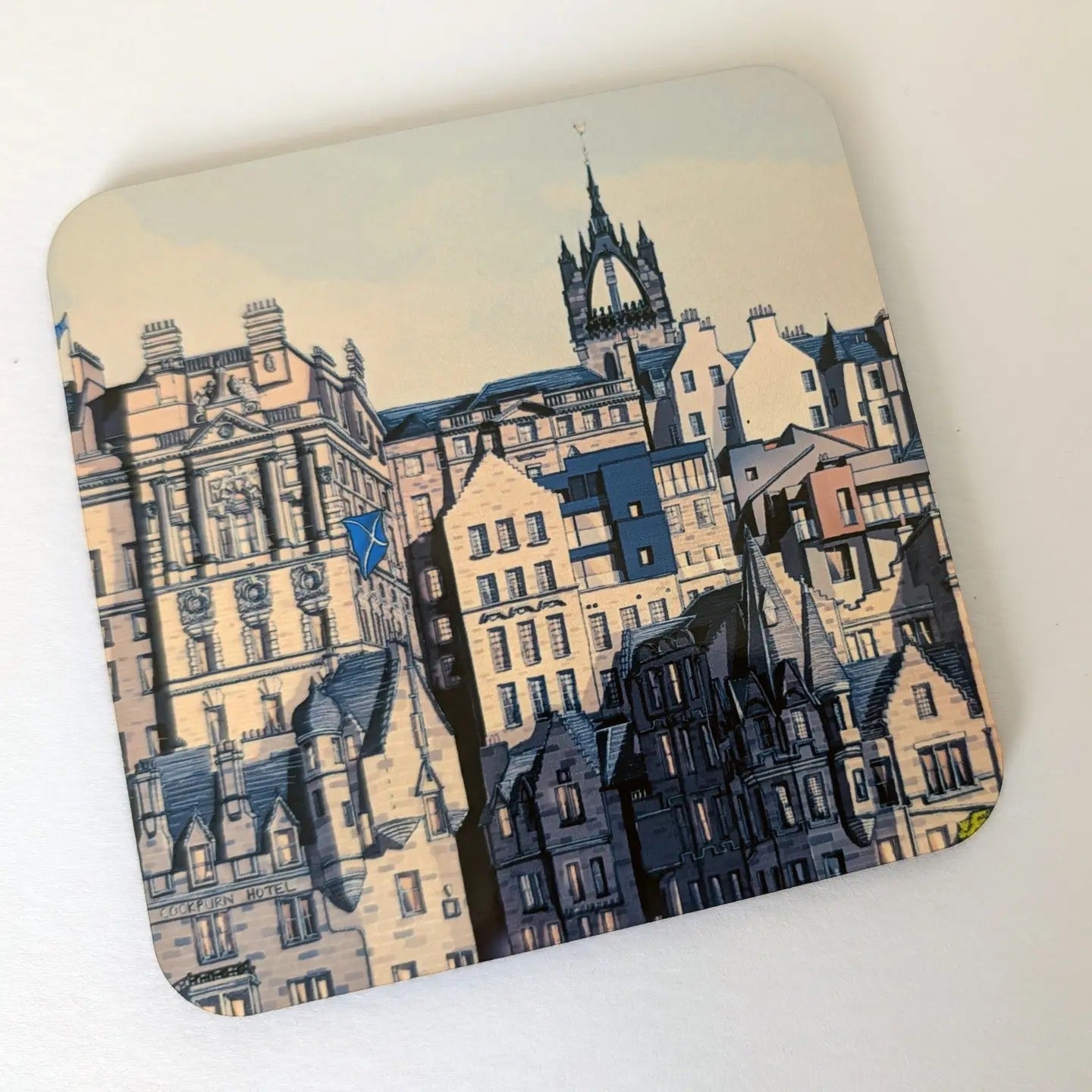 Coaster with an illustration of Edinburgh old town buildings.