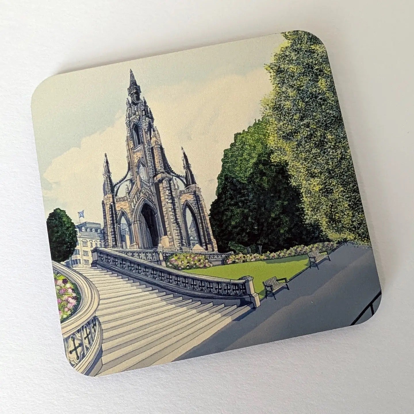 Coaster with an illustration of the Scot Monument on a white background.