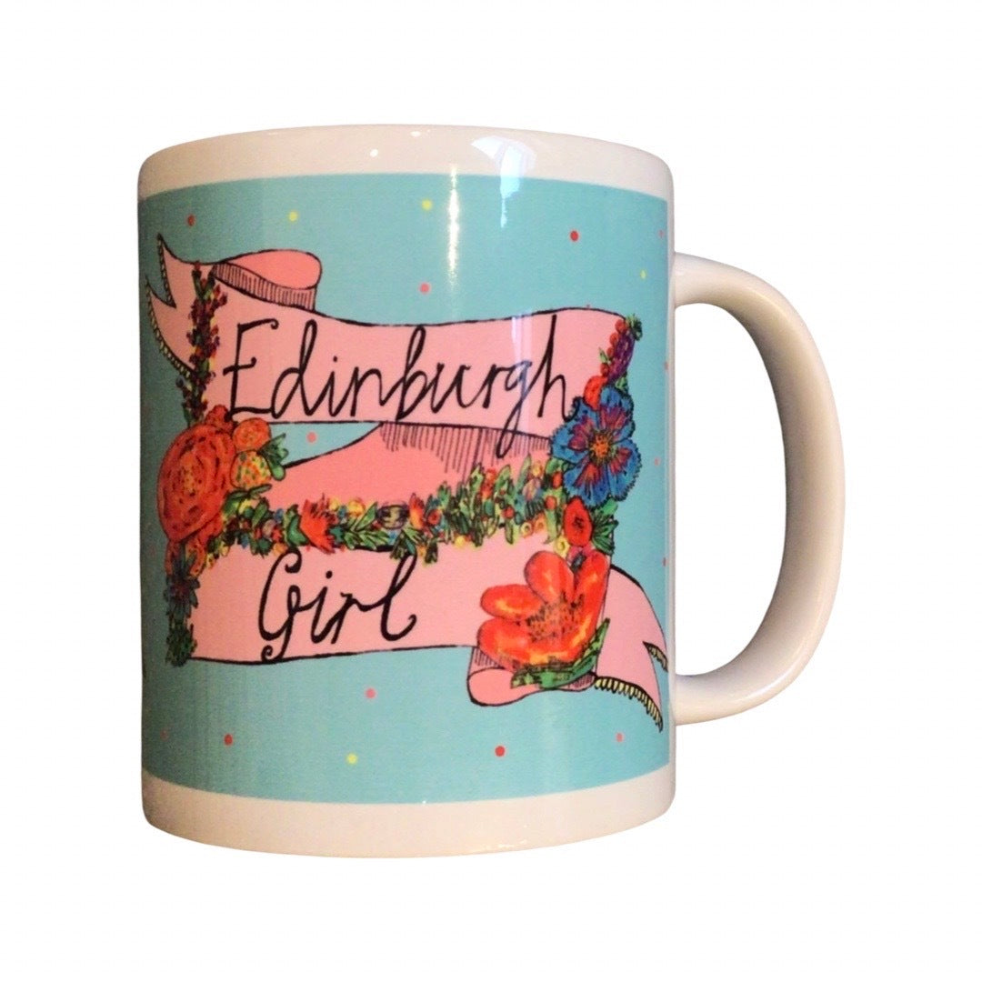 Edinburgh girl mug featuring the text 'Edinburgh Girl' written inside a banner and surrounded by flowers on a blue background.