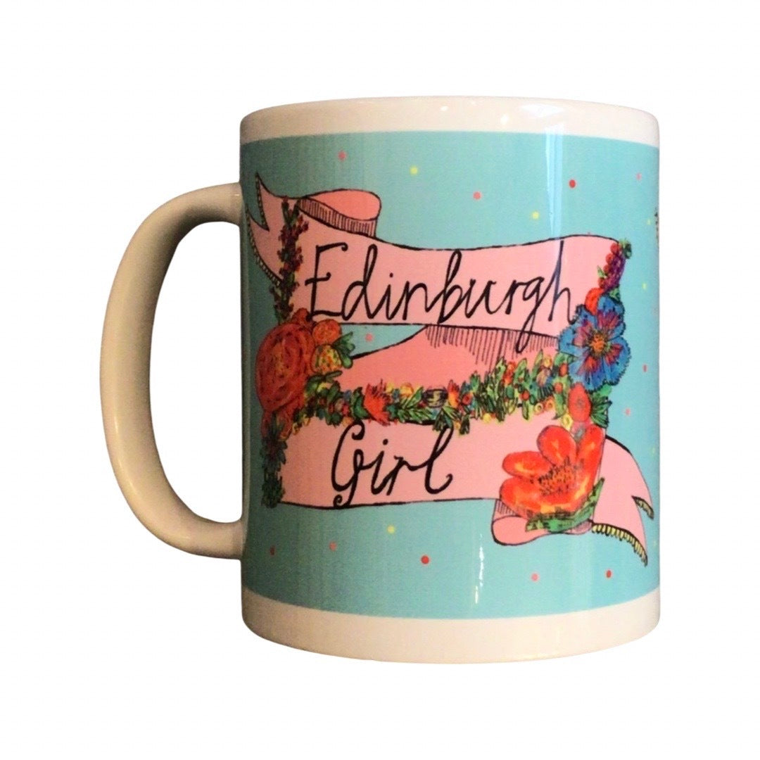 Edinburgh girl mug featuring the text 'Edinburgh Girl' written inside a banner and surrounded by flowers on a blue background.