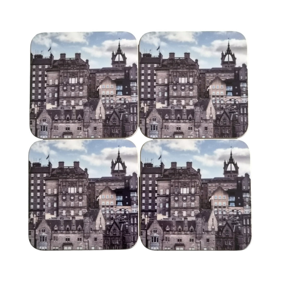 Set of four coasters with a cityscape design on a white background