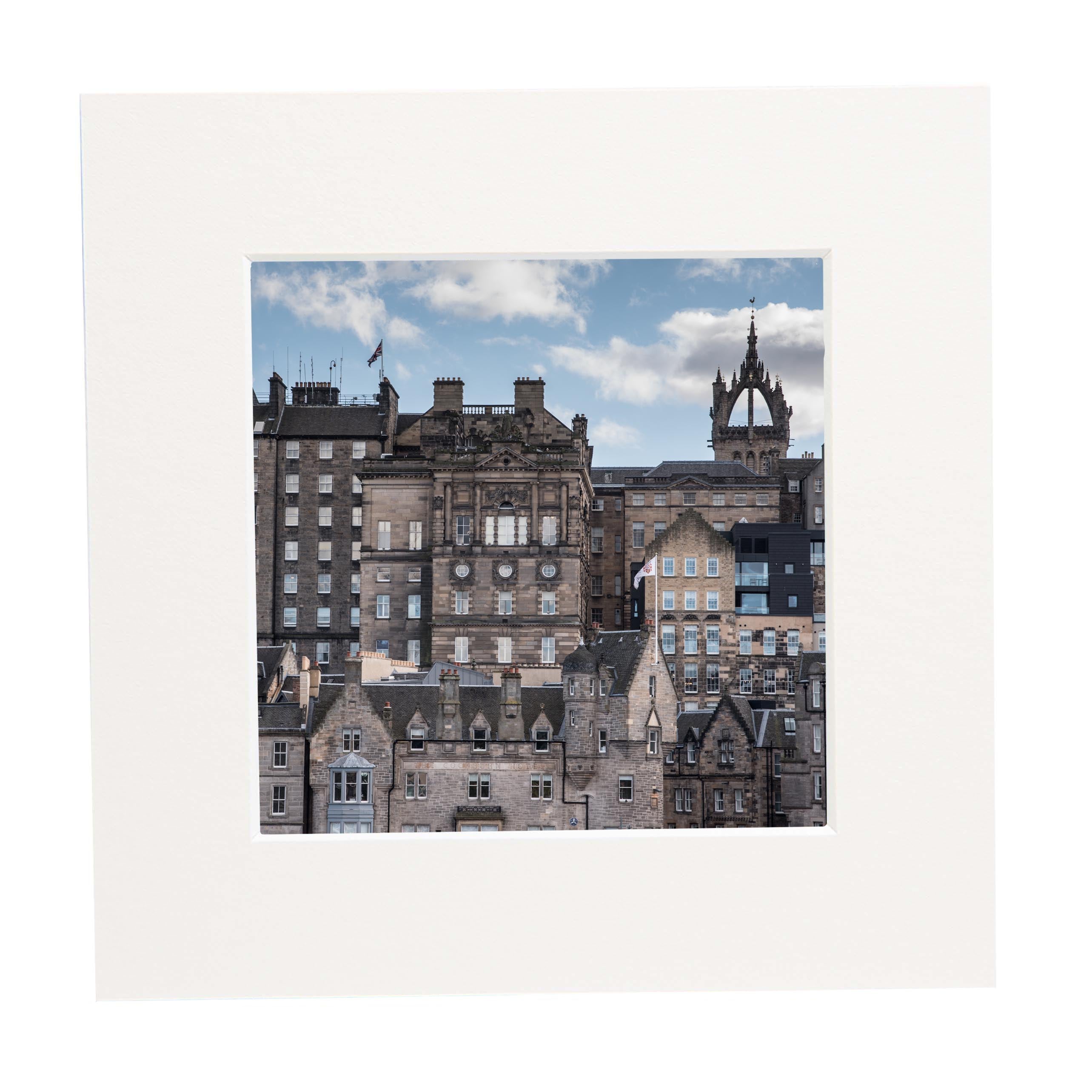 Cityscape with historic buildings under a blue sky with clouds