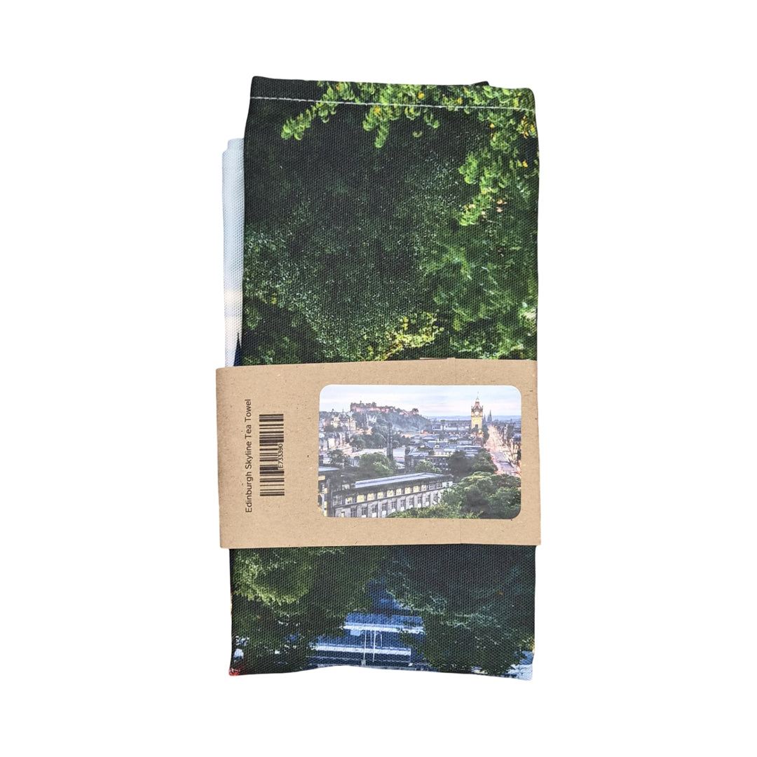 A tea towel showing the Edinburgh skyline wrapped in a brown paper sleeve. 