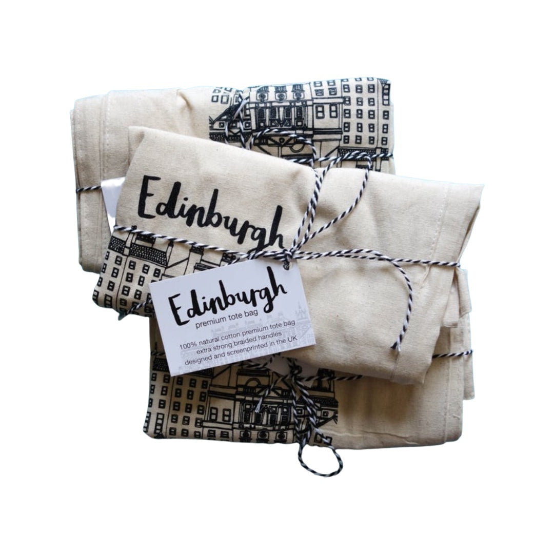 A beige cotton tote bag with an illustration of Edinburgh's skyline in black on the front.