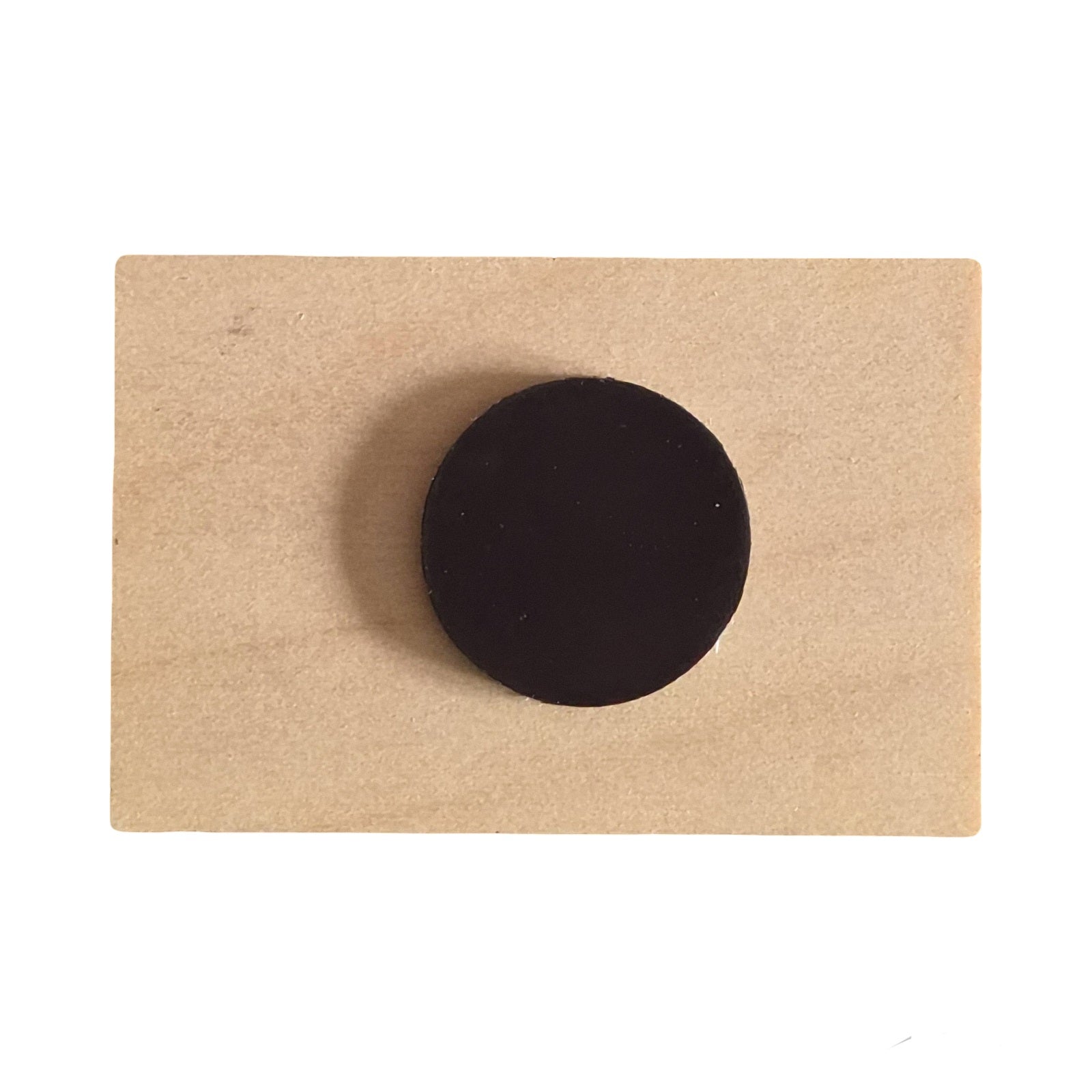 The back of a wooden magnet on a white background. 