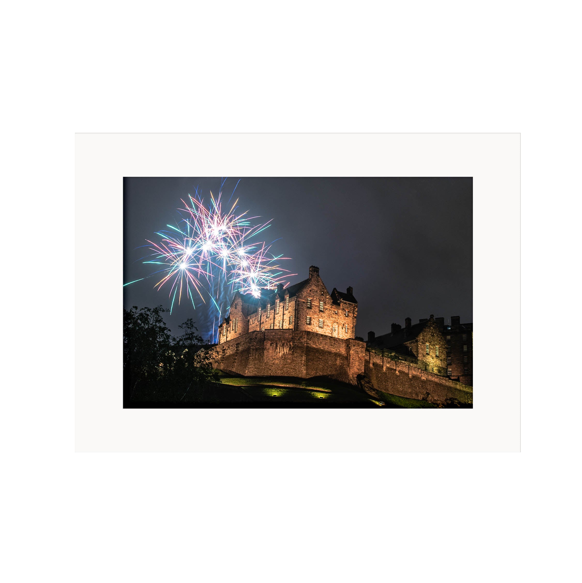 An image of Edinburgh Castle with fireworks above it in a mount. 