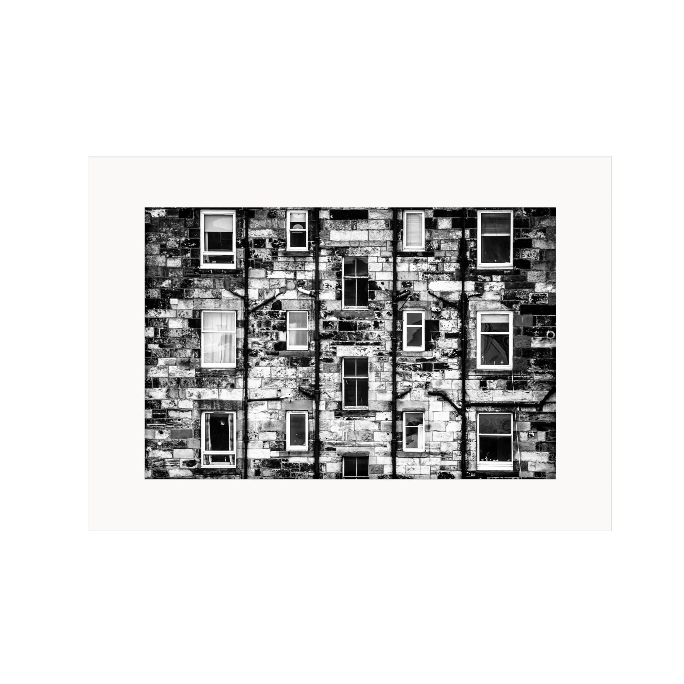 A black and white image of Edinburgh tenements showing the windows and brickwork in a mount