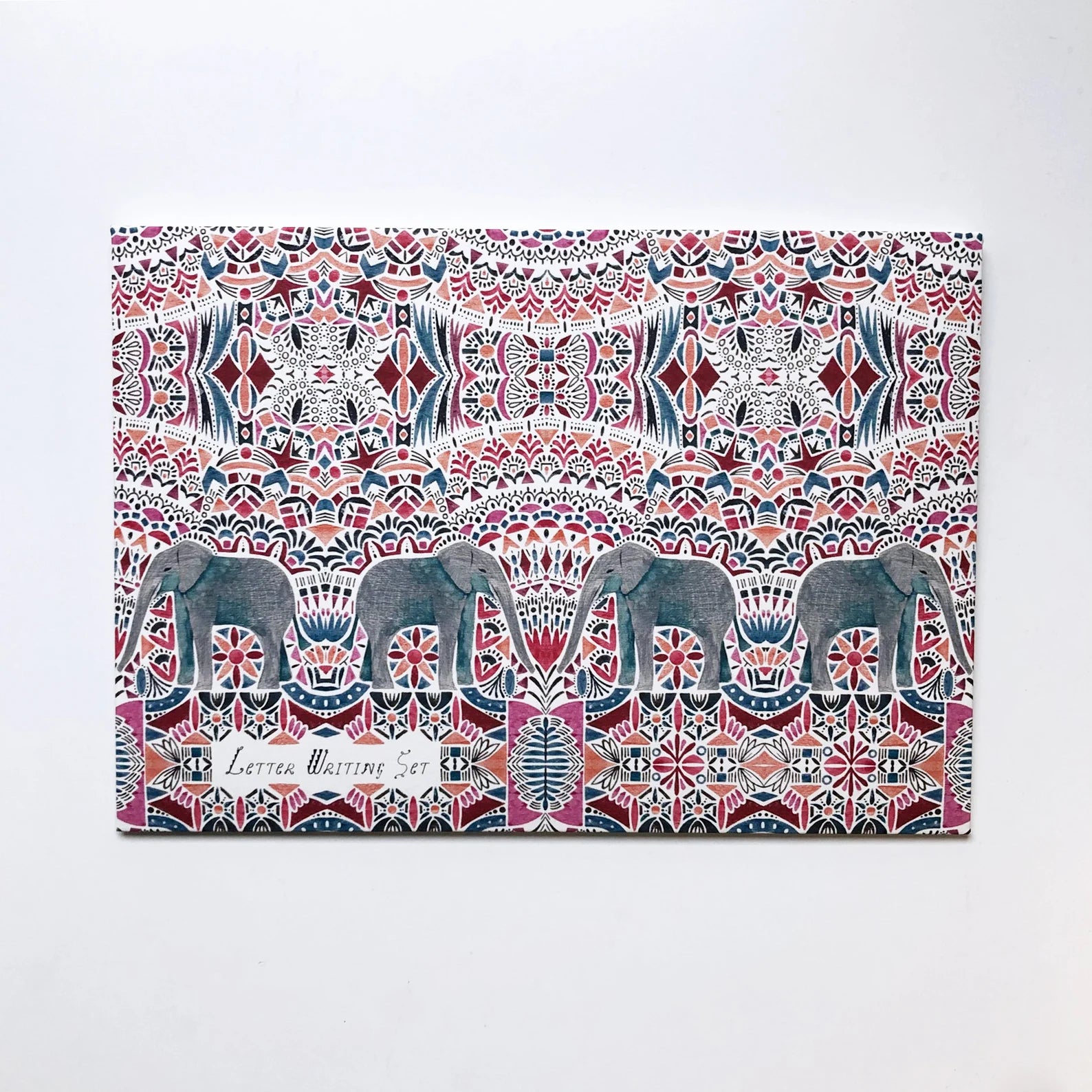 Decorative packaging with elephant pattern on a white background.