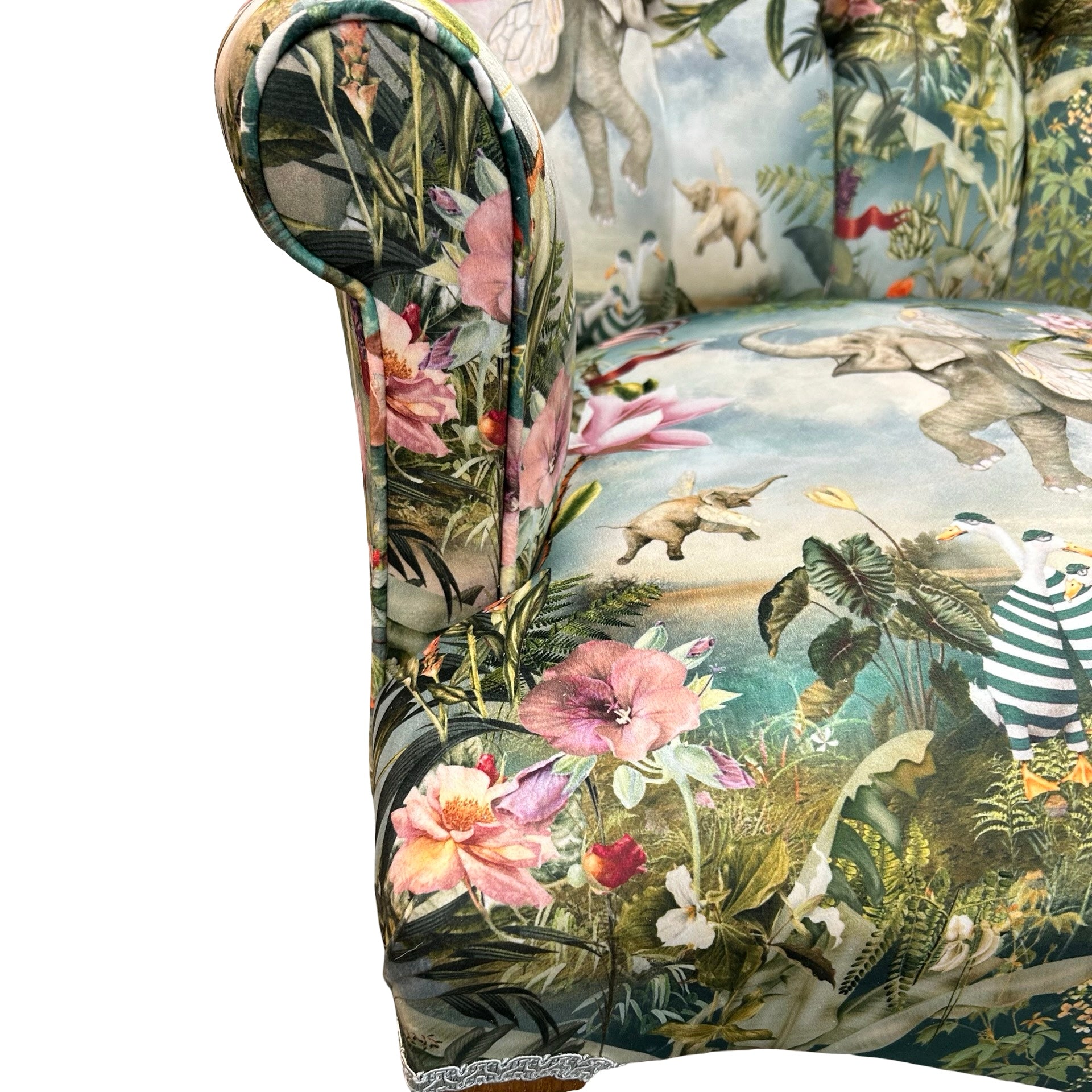 Decorative armchair with a floral and animal pattern on a white background.