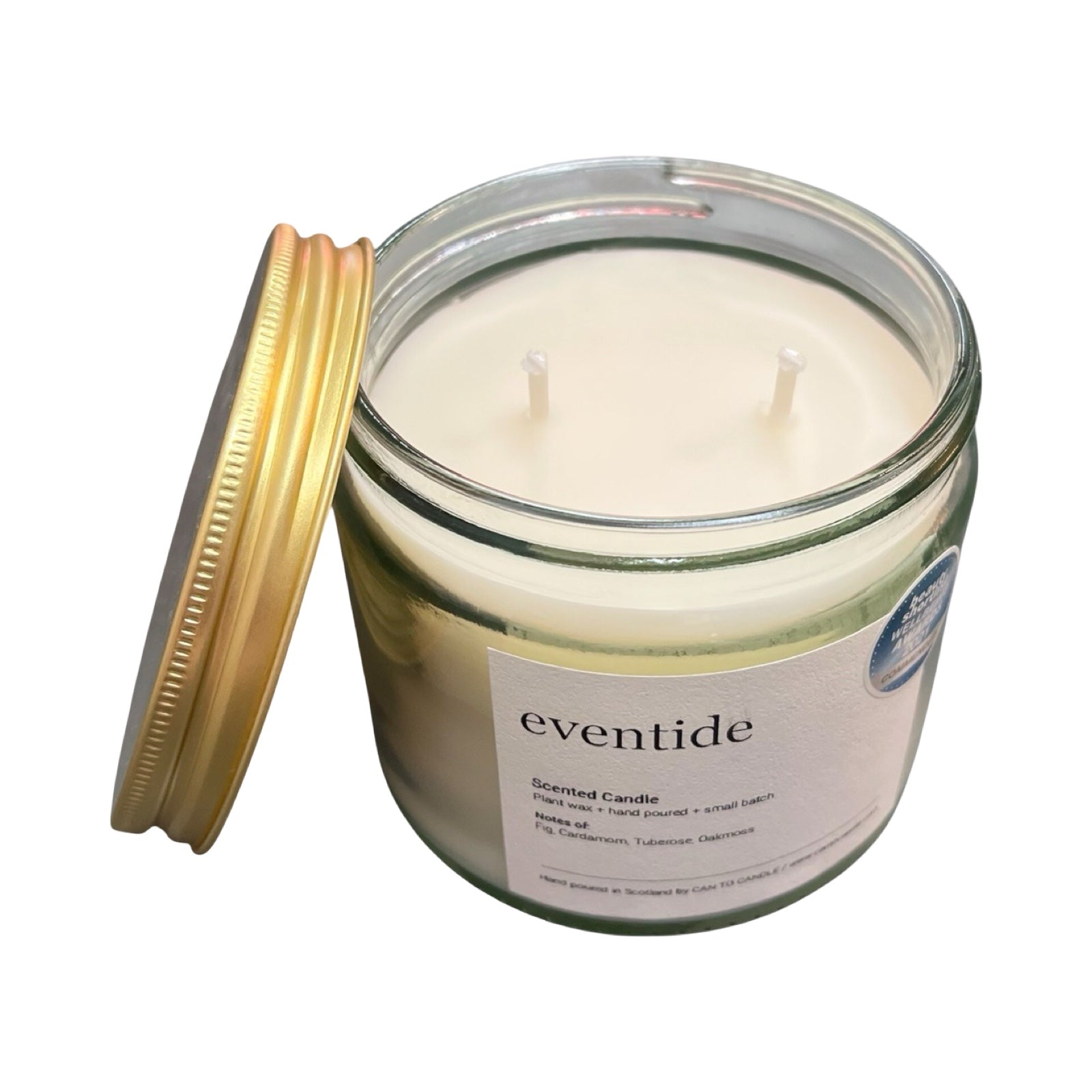Glass candle jar with a gold lid labeled 'eventide' on a white background.