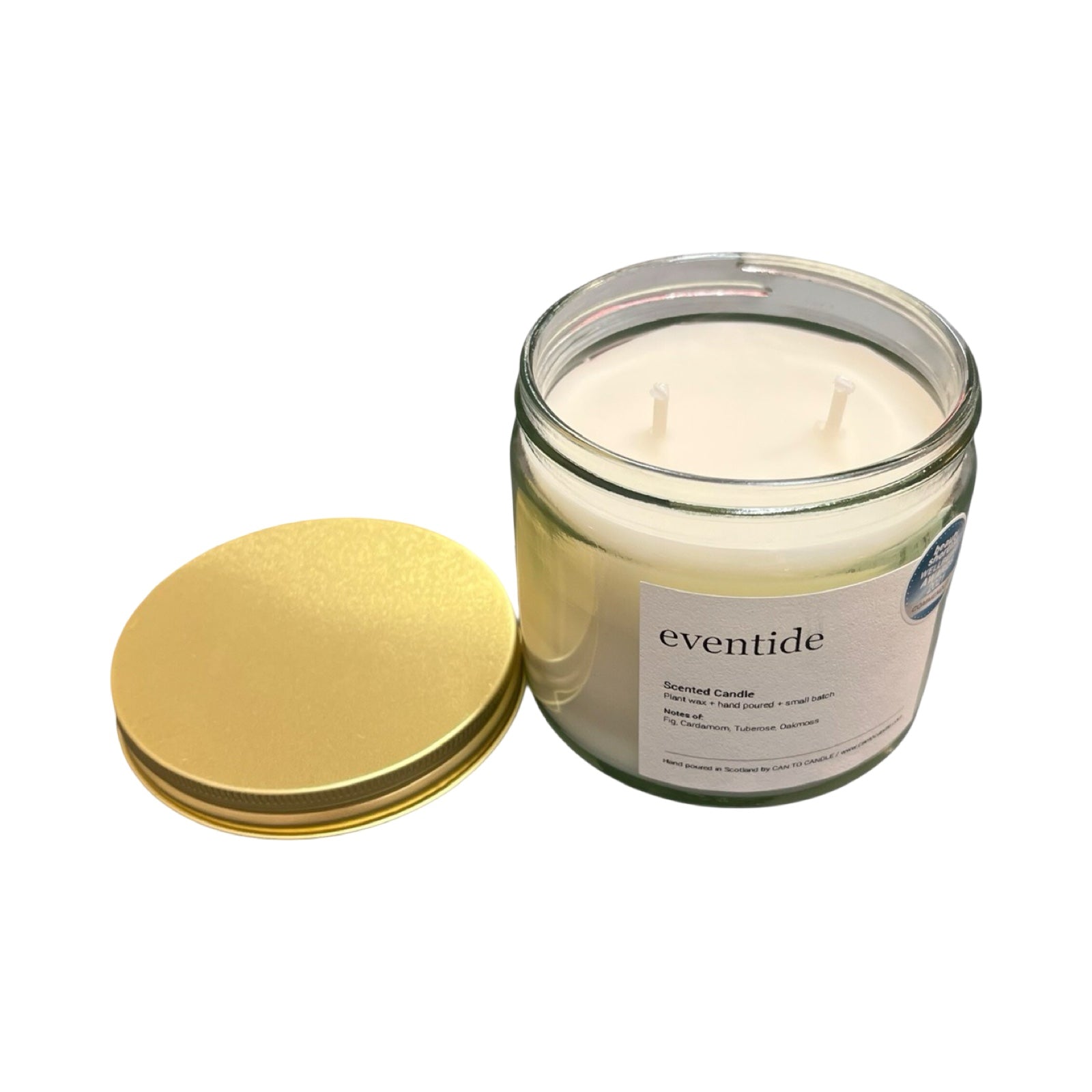 Glass candle jar with gold lid and 'eventide' label on a white background.