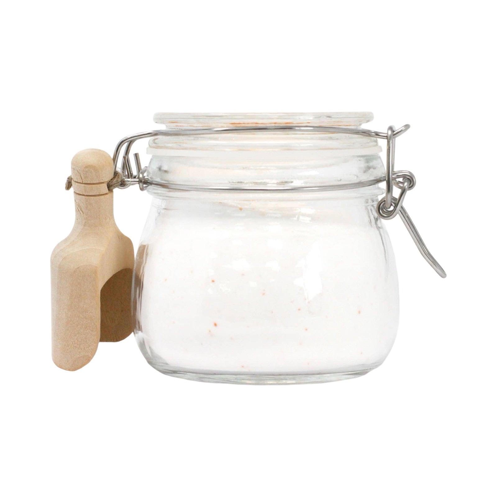 The side view of a glass kilner jar filled with fairy dust and a small wooden scoop