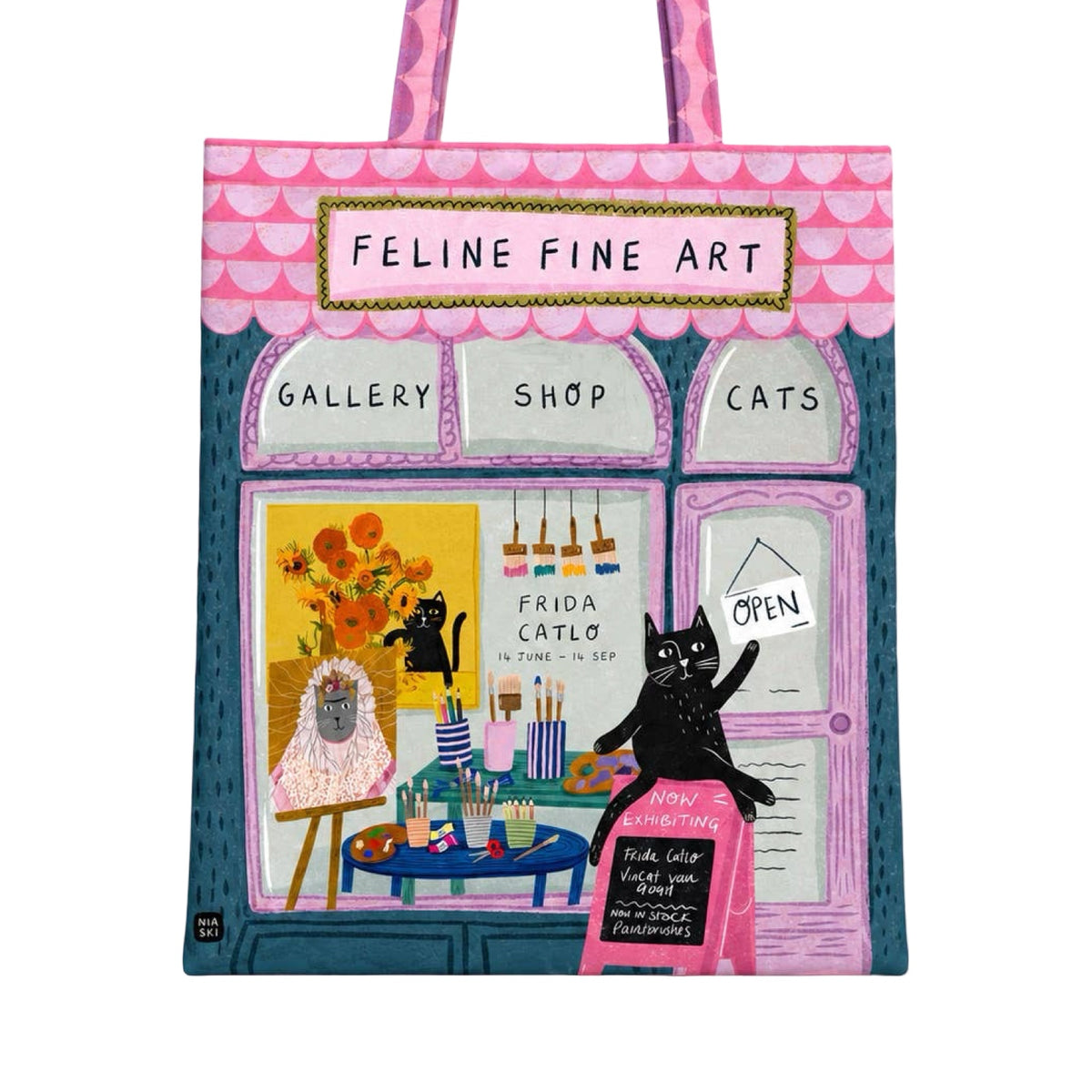 A tote bag featuring a whimsical illustration of a storefront labeled 'Feline Fine Art' with a pink roof, three arched windows reading 'Gallery', 'Shop', and 'Cats', and two black cats depicted in the scene.