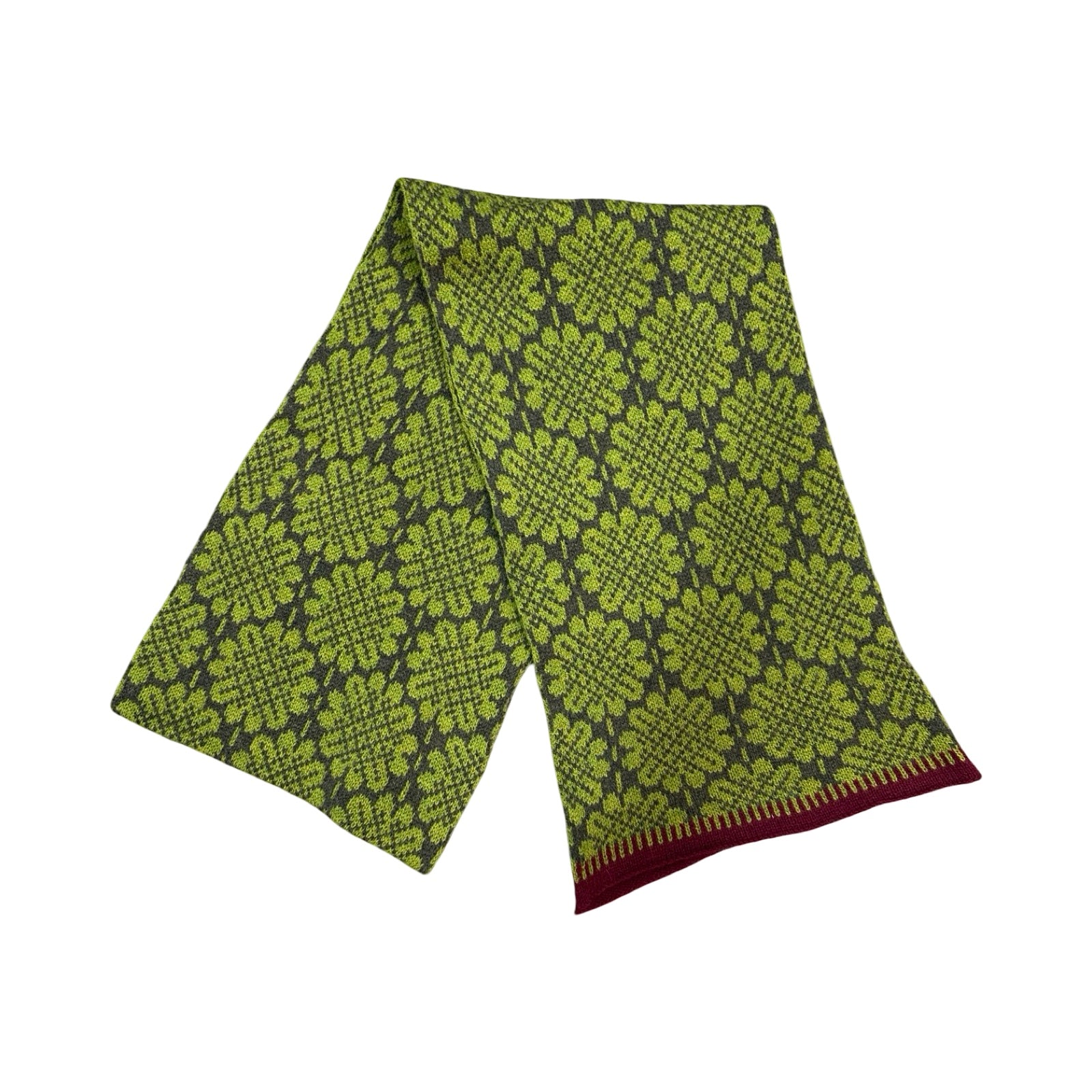 A 100% lambswool knitted scarf with a green daisy pattern against a brown background with contrasting purple edges.