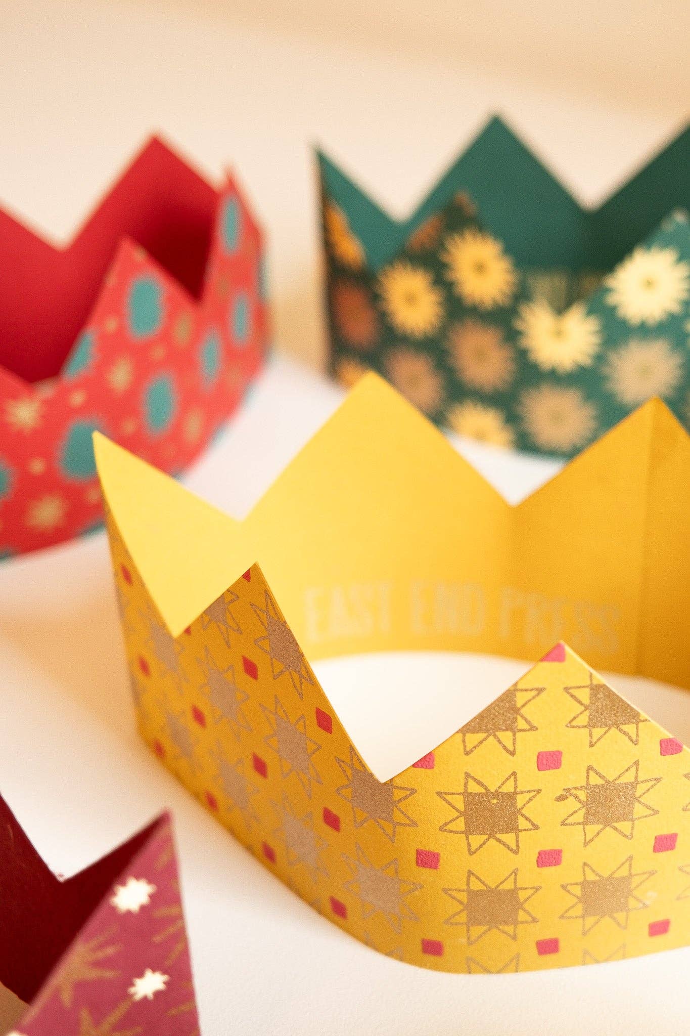 Colourful paper crowns on a light background.