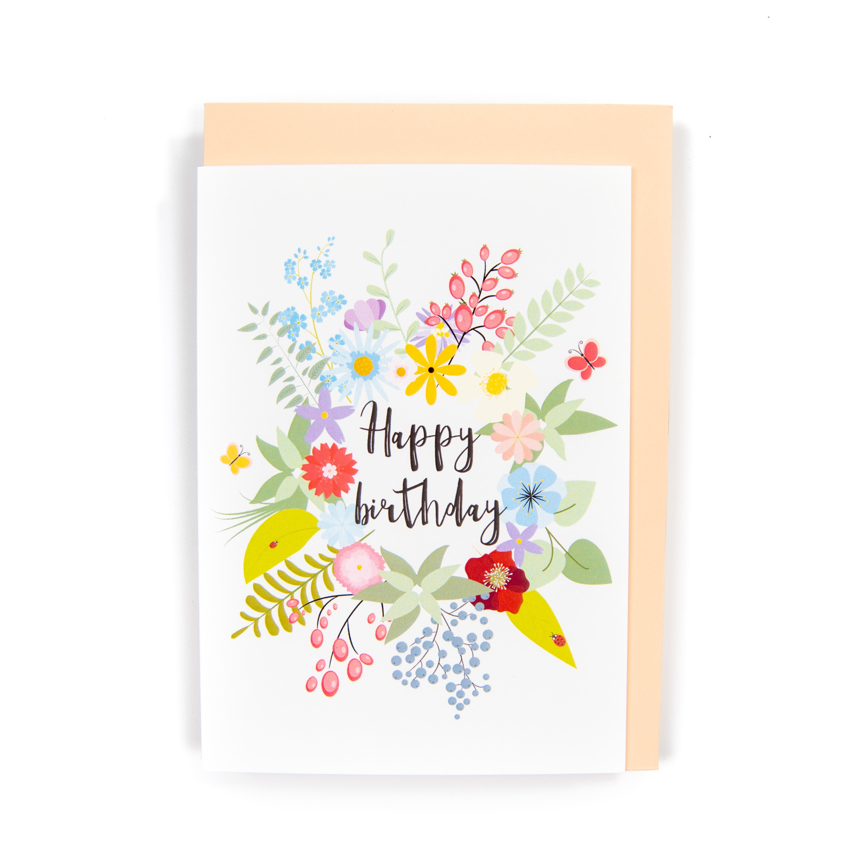 A floral birthday card with a variety of colourful flowers and the text 'Happy birthday' in the centre, presented with an orange envelope.