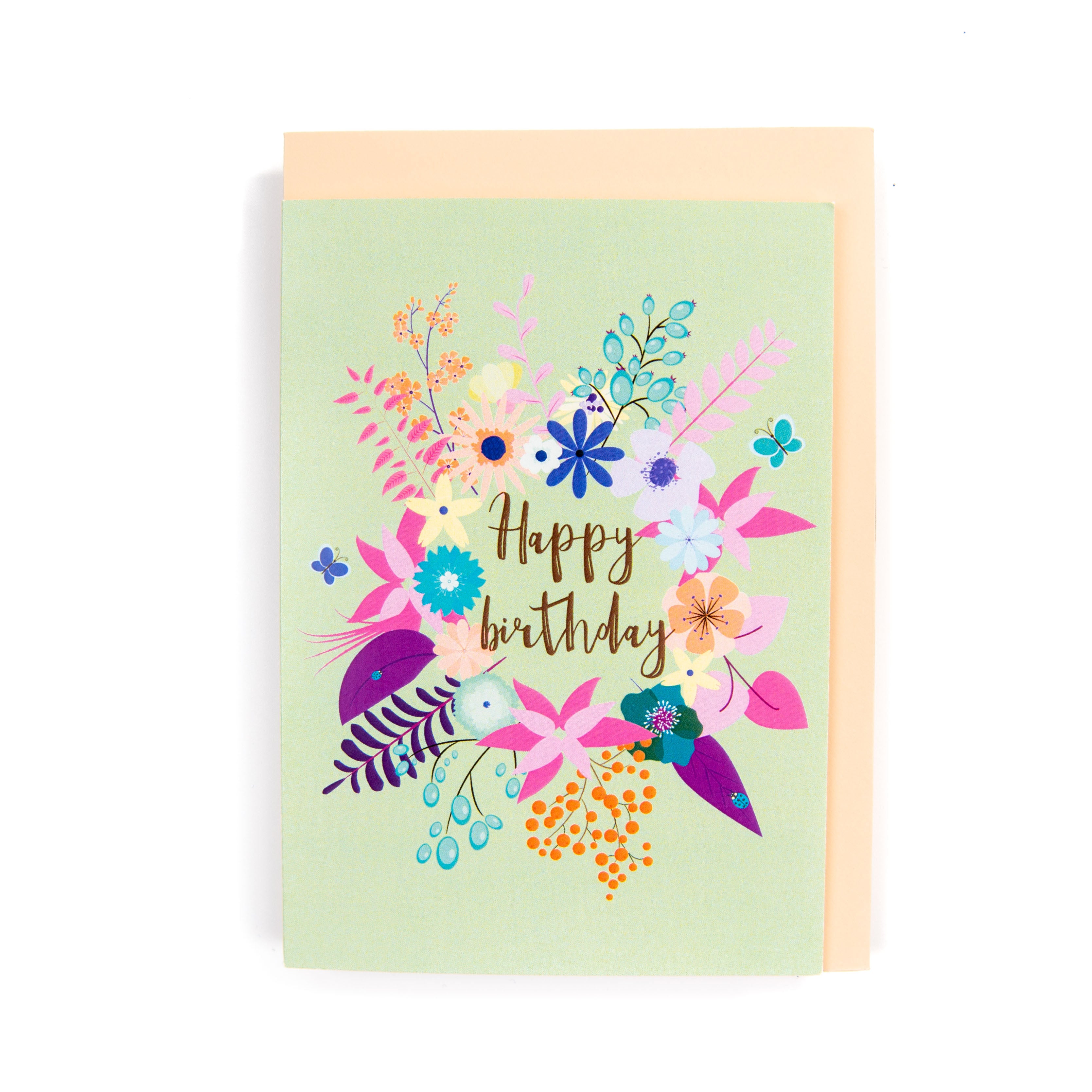 A floral birthday card with a variety of colourful flowers and the text 'Happy birthday' in the centre, presented with an orange envelope.