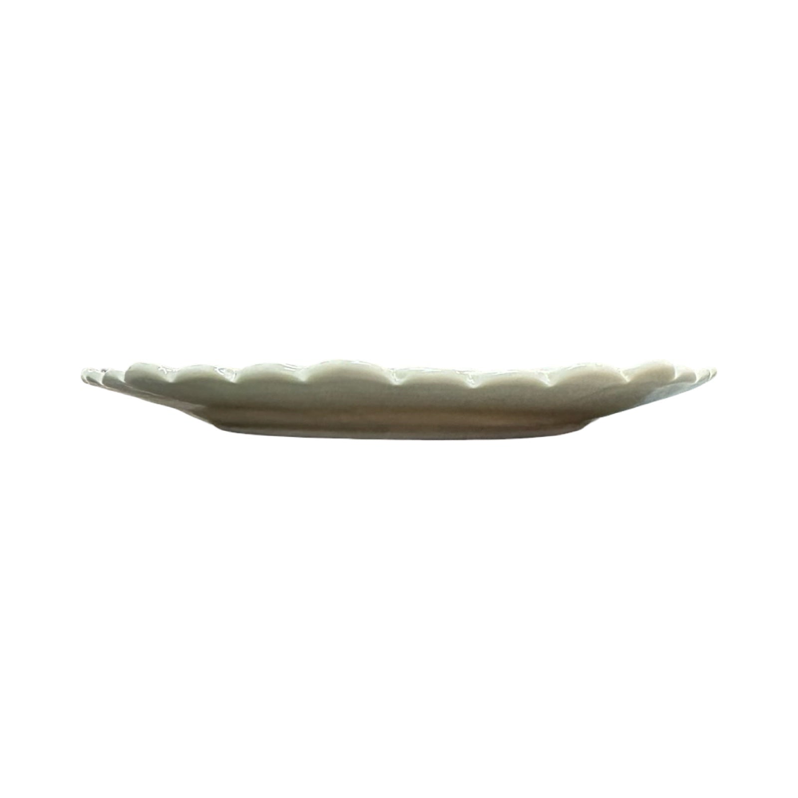 White ceramic plate with textured rim on a white background.