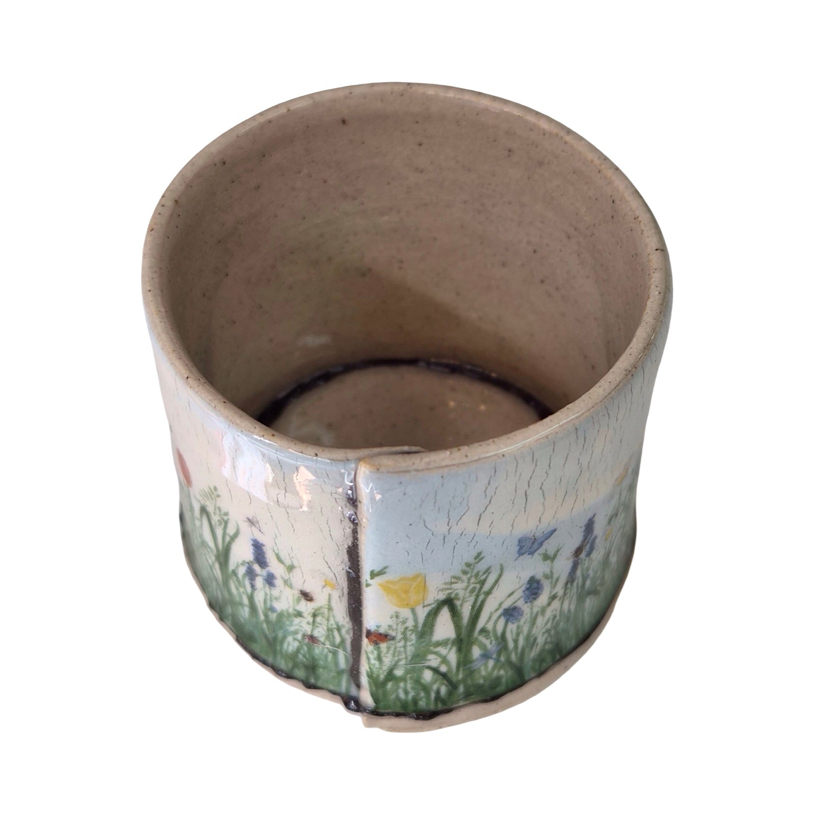 Ceramic planter with floral design on a white background.