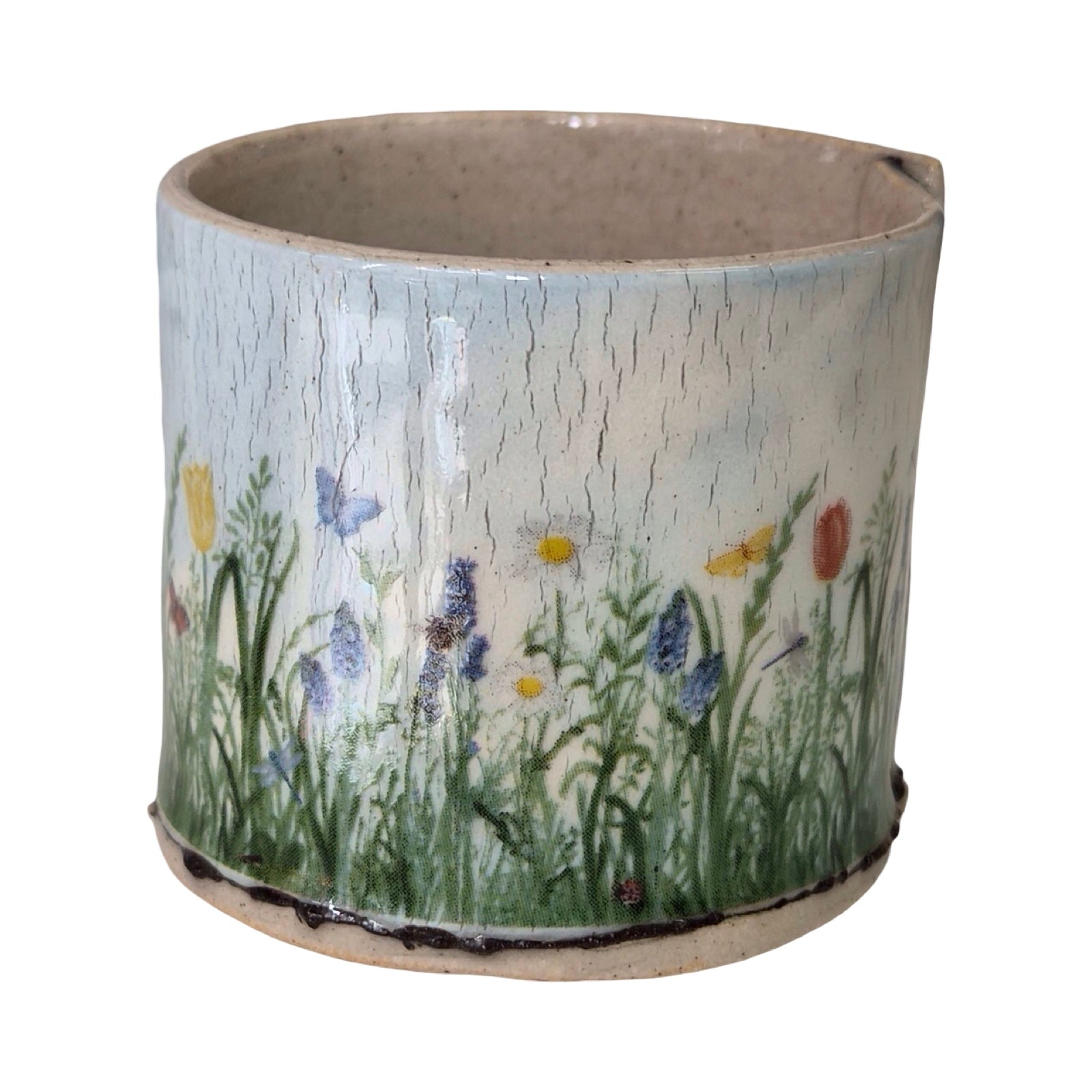 Ceramic planter with floral design on a white background.