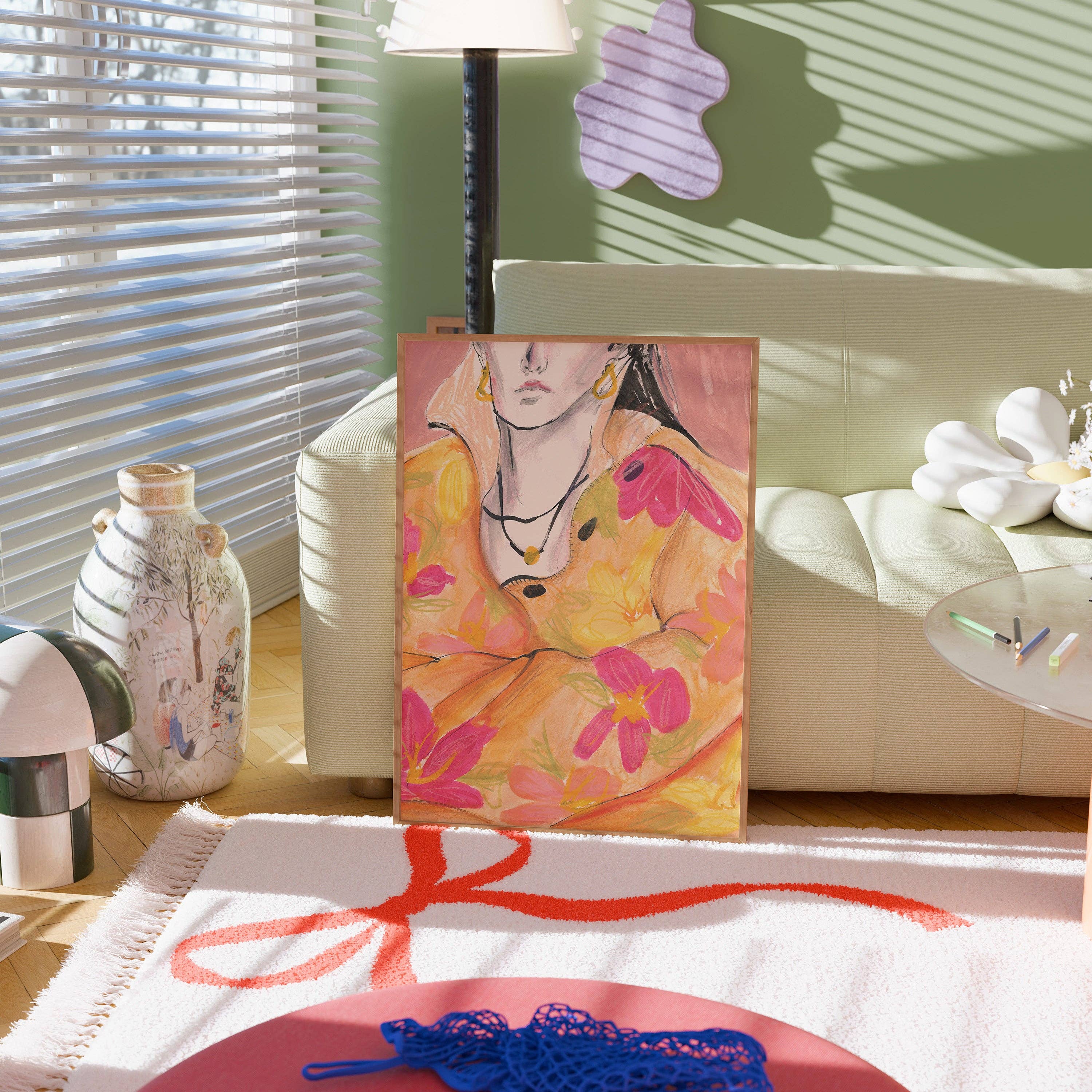 A colourful portrait painting of a woman in a yellow dress with pink flowers, displayed on a canvas in a modern living room setting.