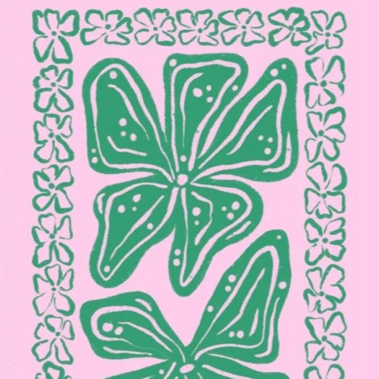This colourful rectangular print features green leaves in the centre surrounded by a green leaf border against a pink background. 