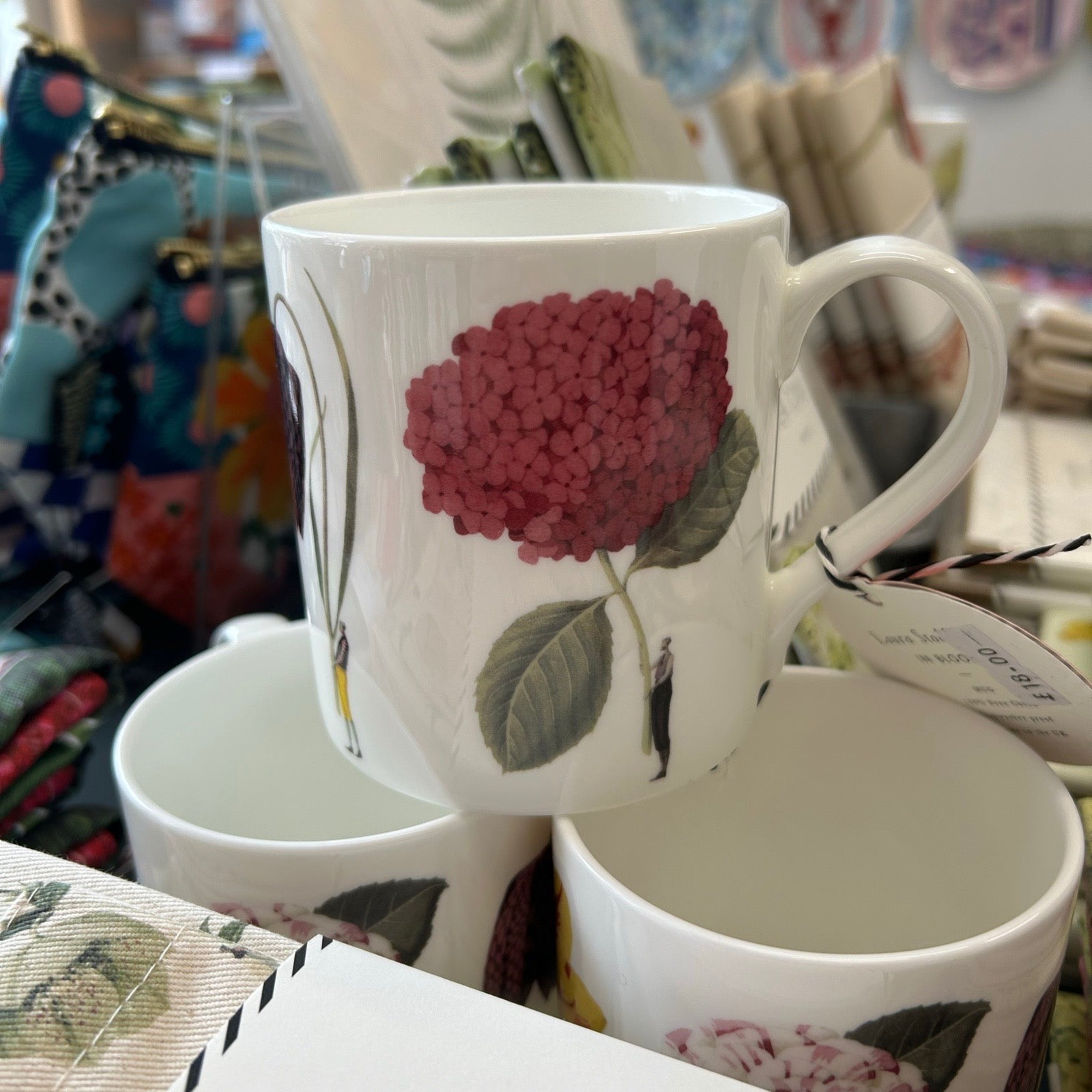 White mug with floral design on a blurred background.