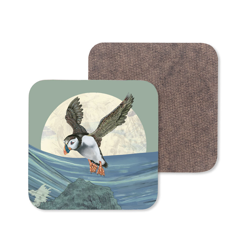 An image of a wooden coaster with a flying puffin design.