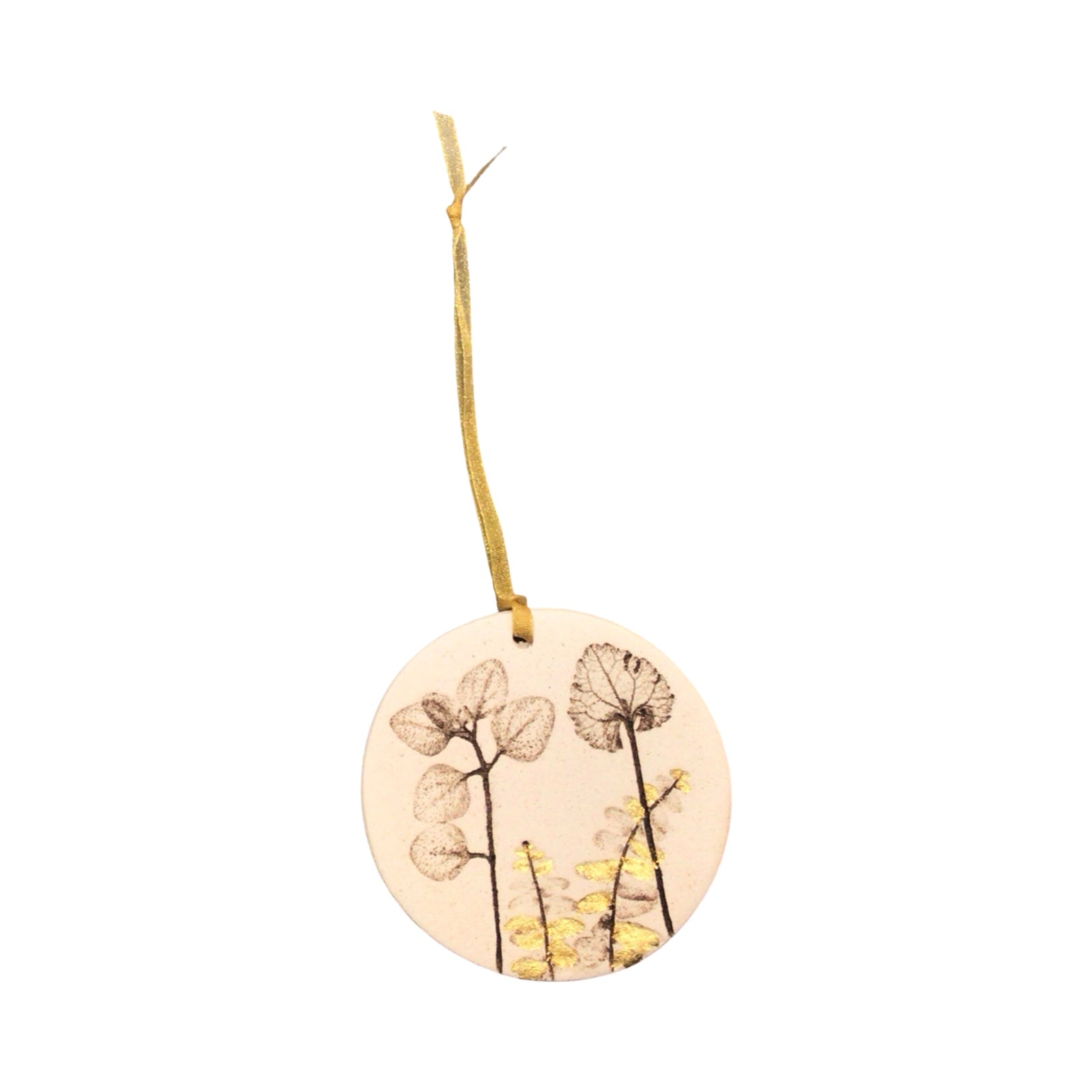 Round ceramic ornament with floral design and string on a white background