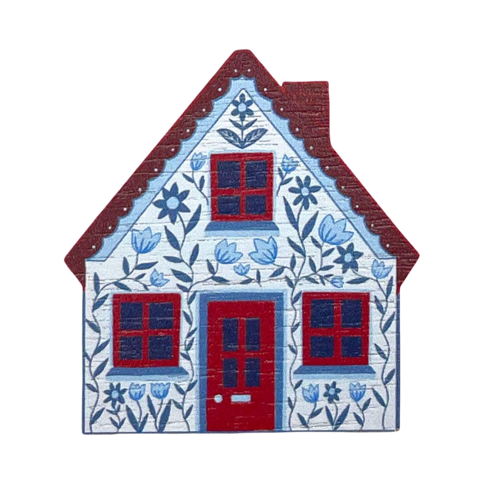 A decorative house-shaped wall brooch featuring a white wood-grain texture, blue floral patterns, red roof and door, and blue window panes, shown on a plain white background.