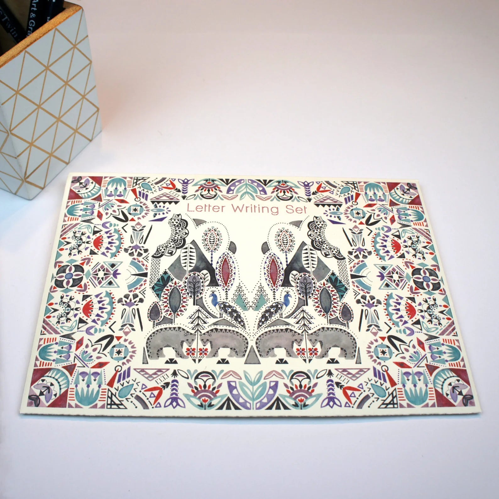 Letter writing set with animal-themed design on a white surface.