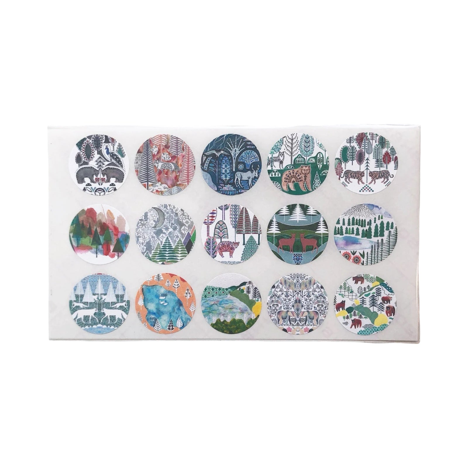 Set of round stickers with nature-themed designs on a white card.