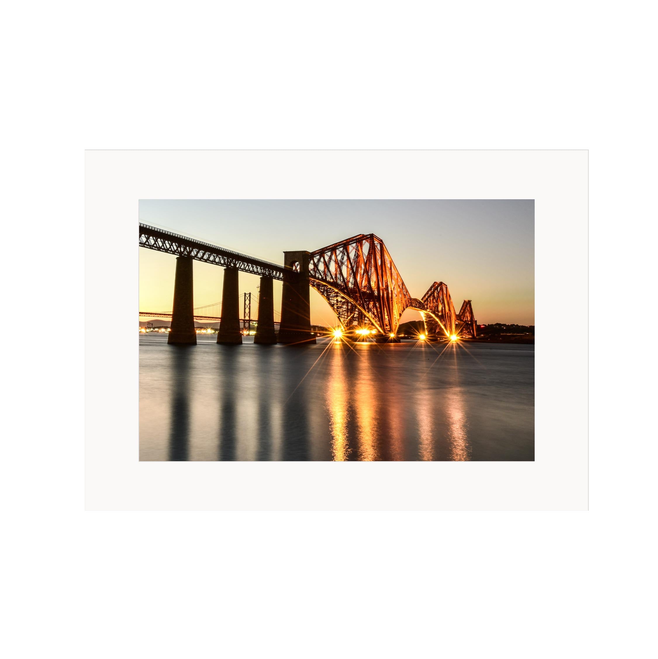 An image of the Forth Bridge at night in a mount. 