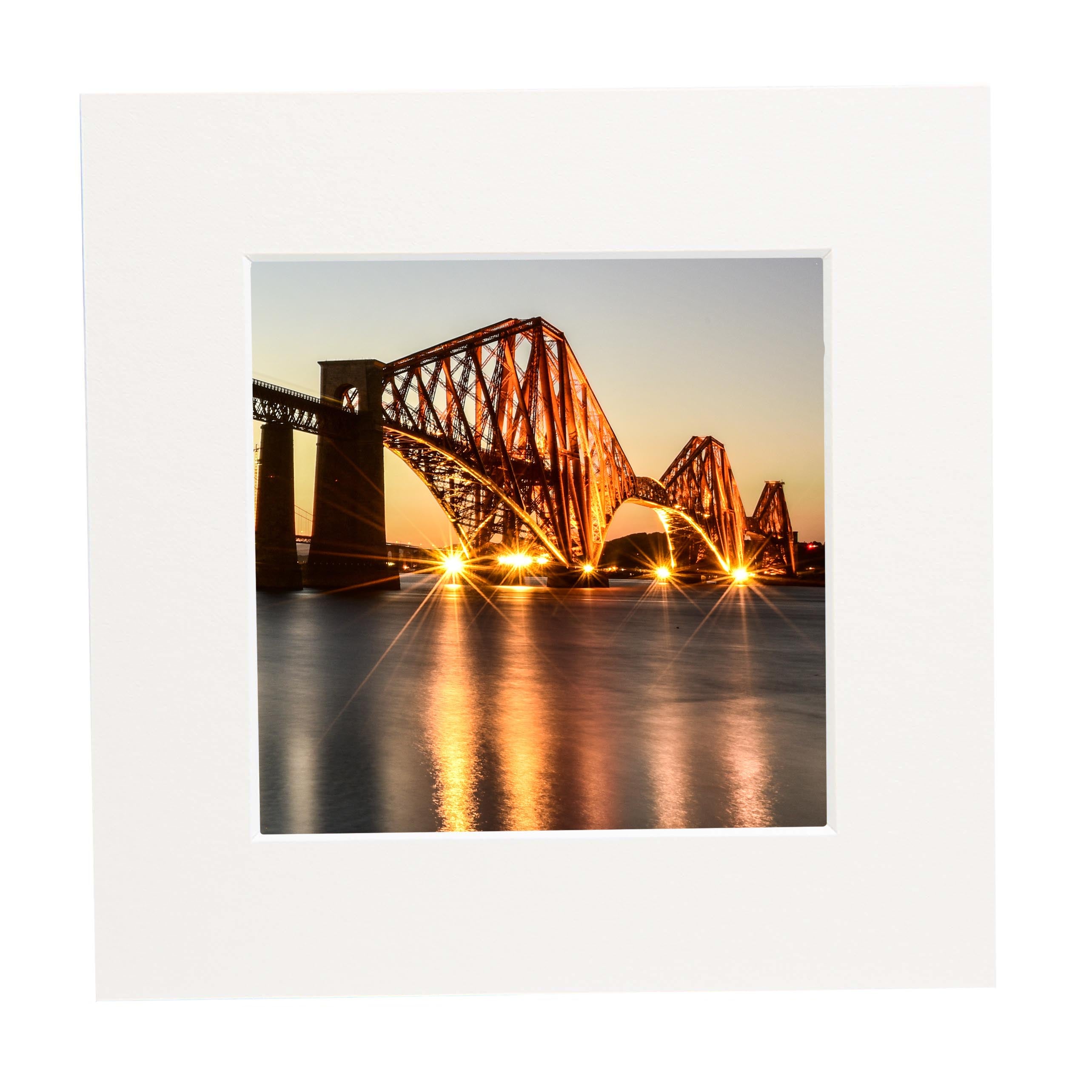 An image of the Forth Bridge at night in a mount. 