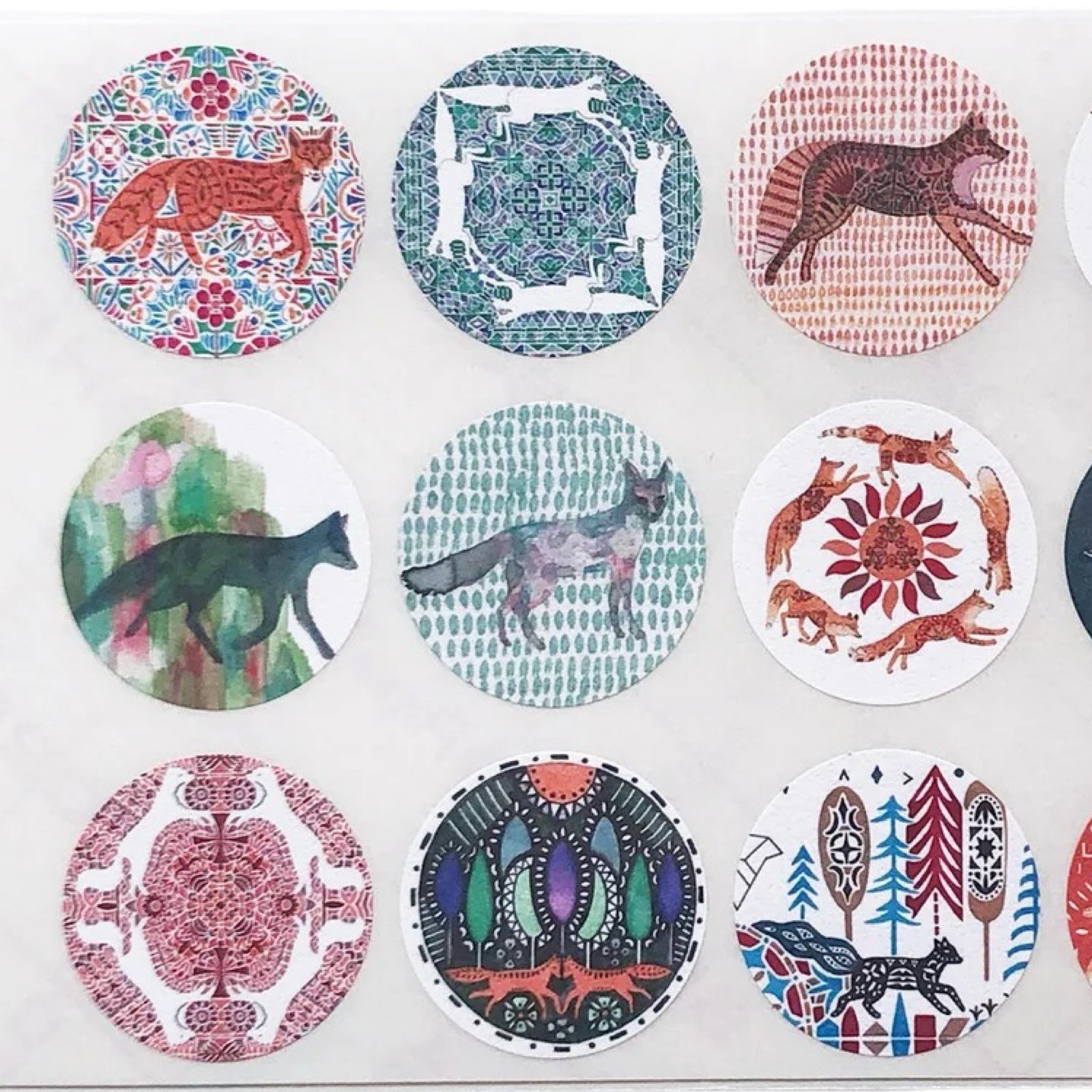 Set of circular stickers with various animal designs on a white background.