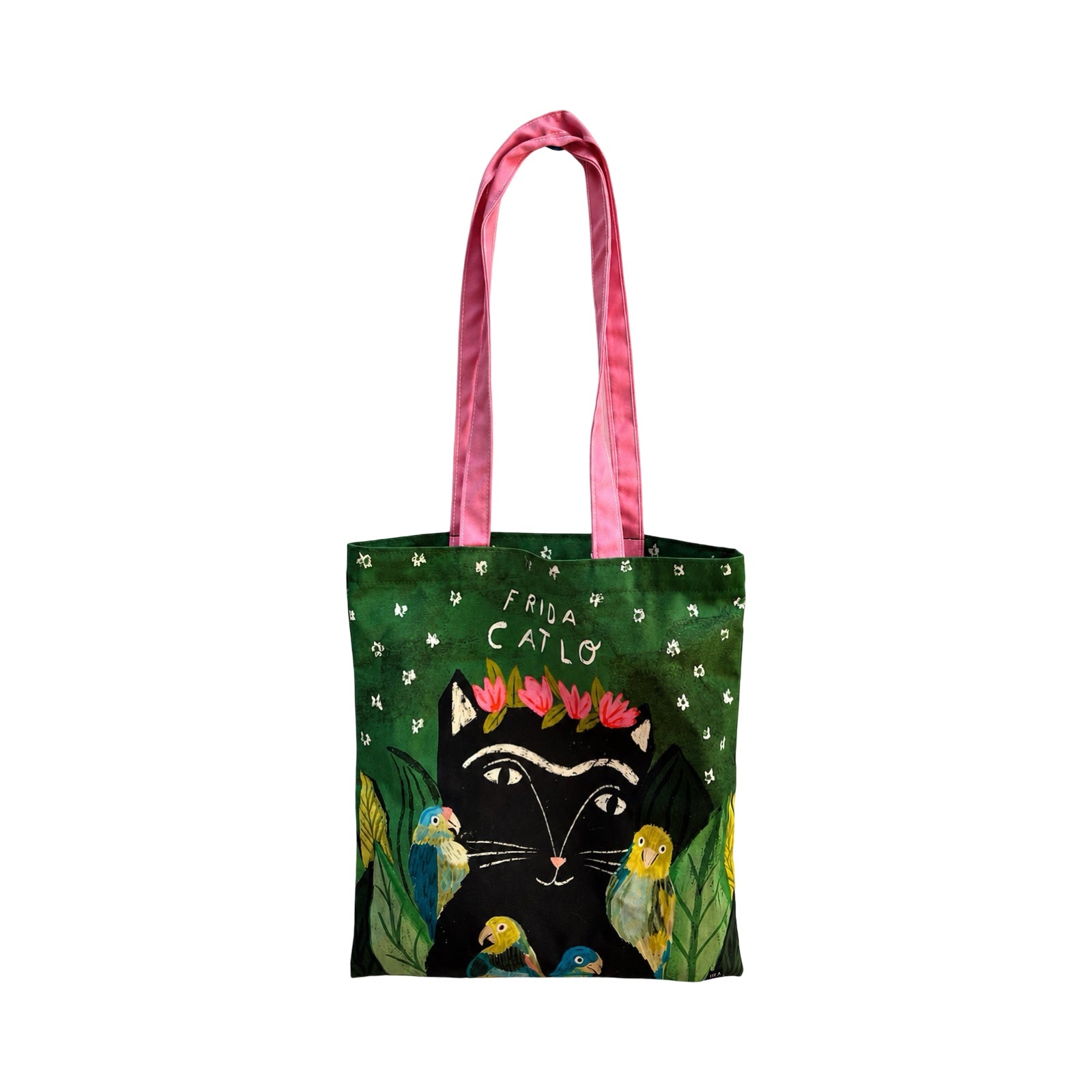 A green tote bag with pink handles, featuring a black cat wearing a pink flower crown, surrounded by colourful birds and white flowers on a white background.