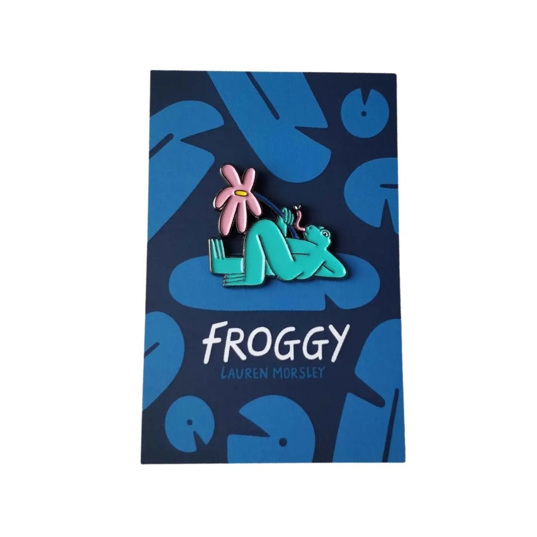Froggy enamel pin badge featuring green frog lying relaxing holding a pink lily.