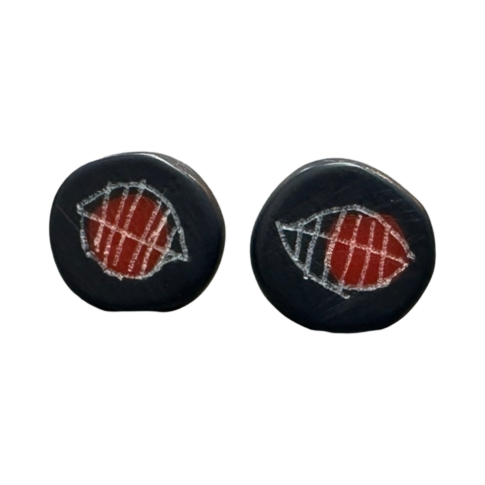 Navy circular stud earrings with a white engraved leaf and a red dot.