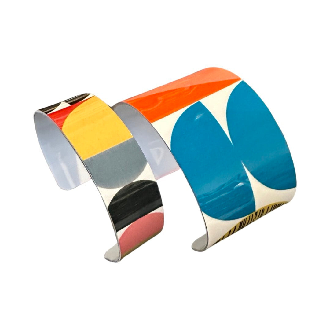 One wide and one narrow geometric cuff bracelets.