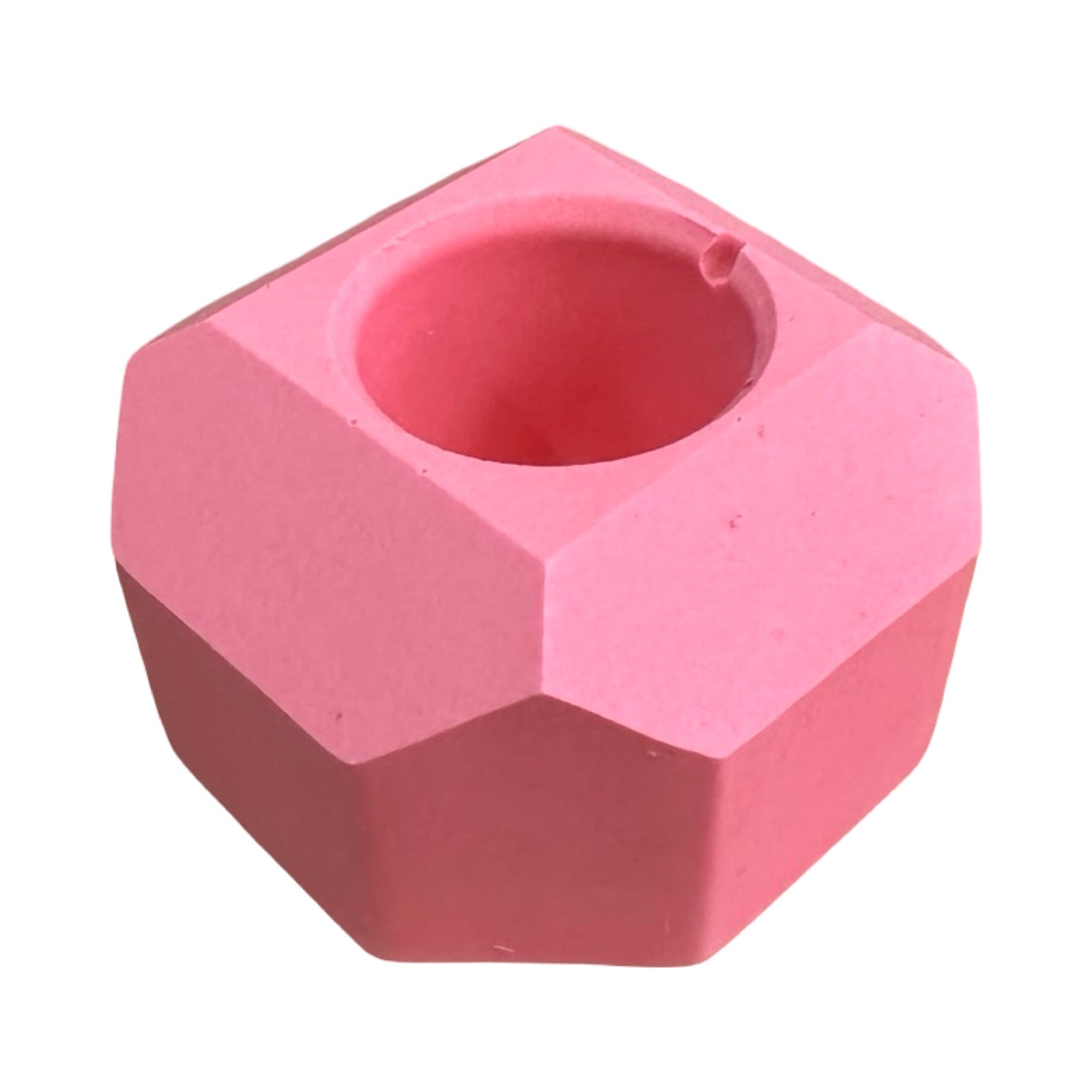 A small geometric shaped dinner candle holder in pink.