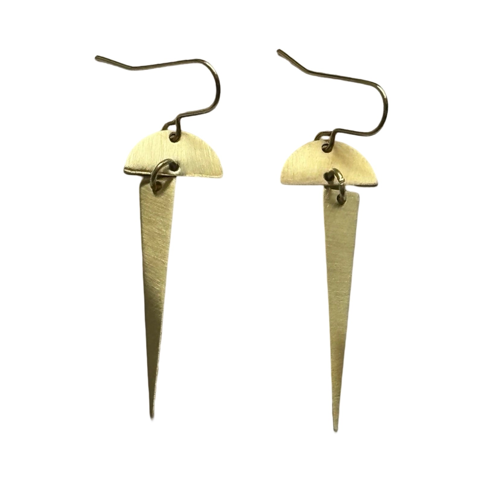 Brass earrings in geometric shapes, an arc with a long triangle hanging below.