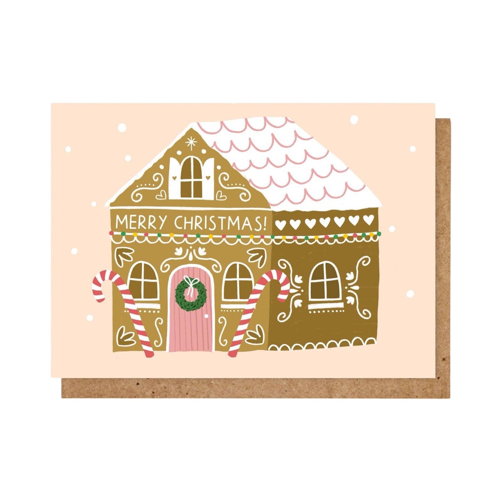 Christmas card featuring a gorgeous gingerbread house cake with candy canes at the entrance and the text 'Merry Christmas' written in white icing.