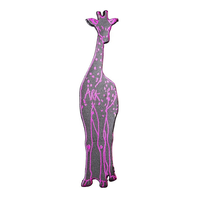 The back of a leather giraffe shaped bookmark with pink neon detail