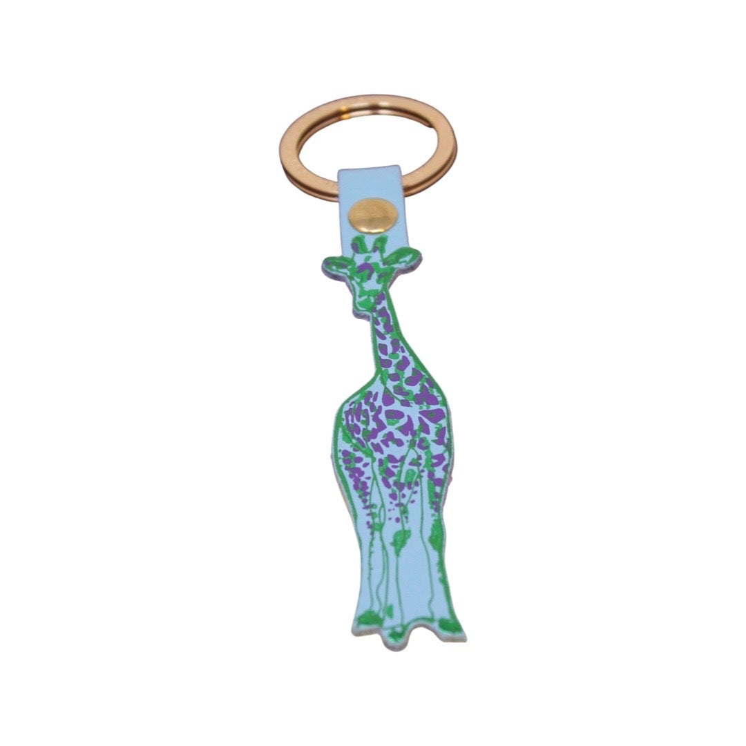 A blue giraffe-shaped leather keyring with a green outline and purple detail and a gold ring.