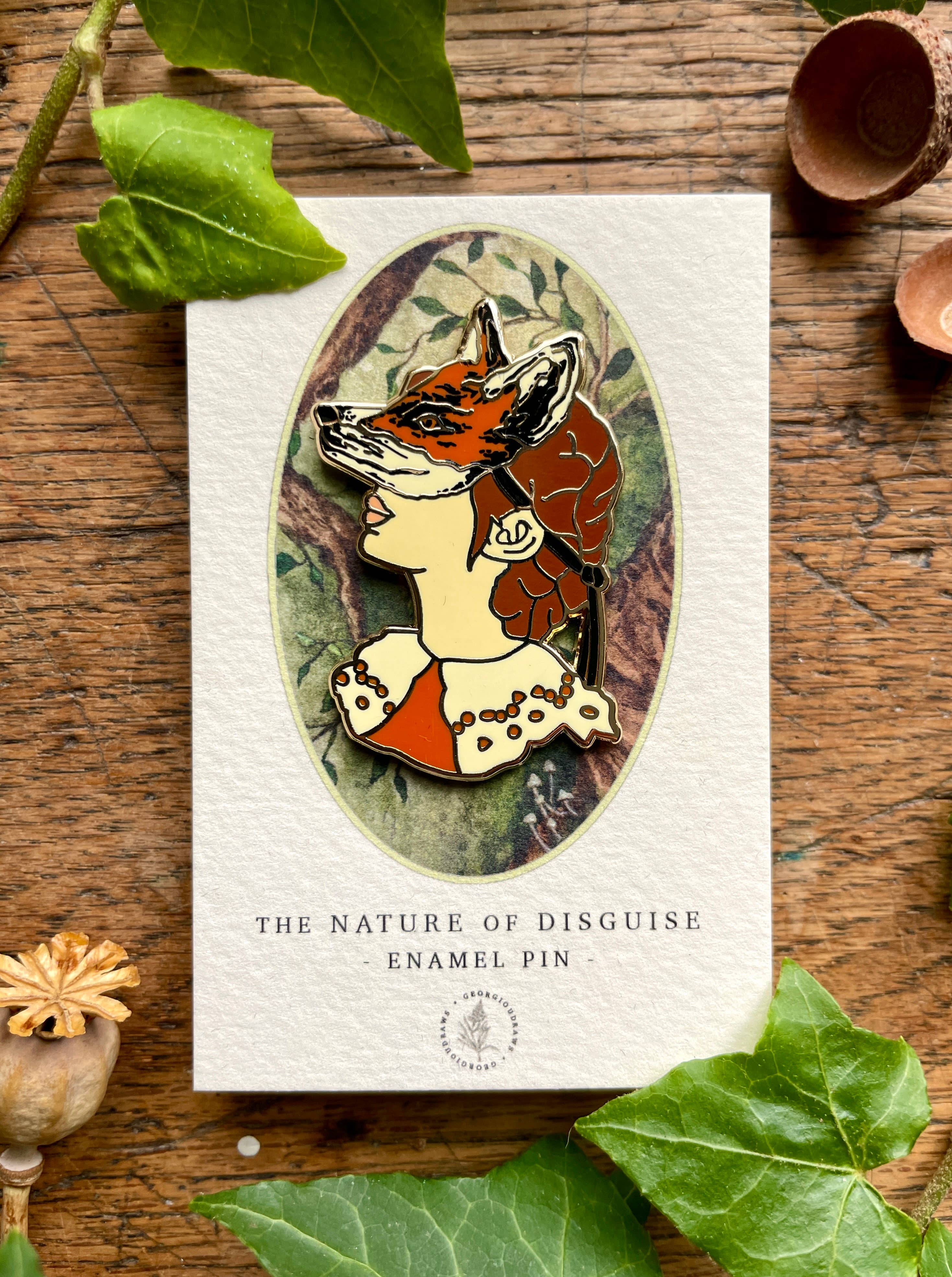 This enamel pin badge features a girl's head wearing a fox mask. 