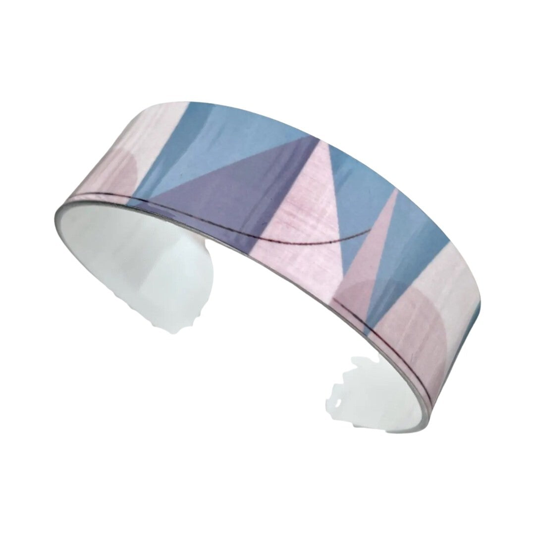 Narrow statement cuff bracelet featuring an abstract light blue, grey and white printed design.