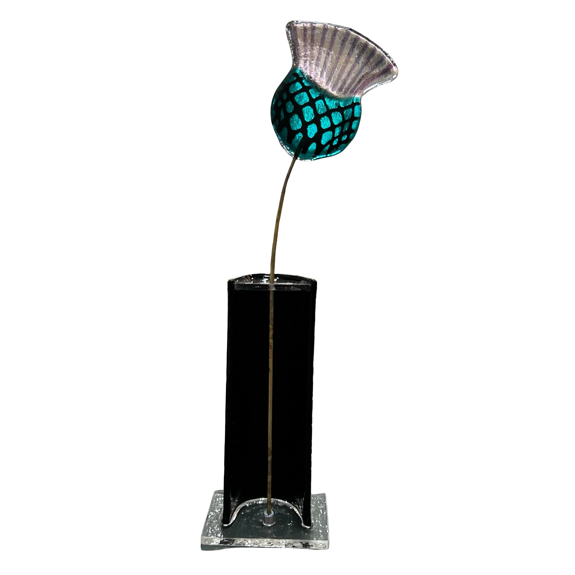 Decorative glass thistle with a blue and silver top on a black cylindrical base with a square base.